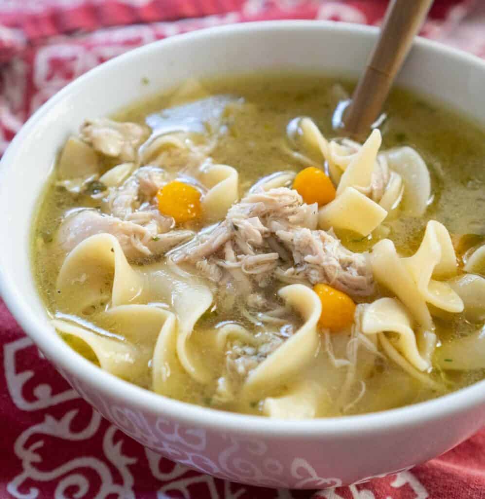 white bowl with chicken noodle soup