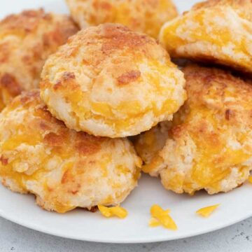 stack of garlic cheddar biscuits on white plate