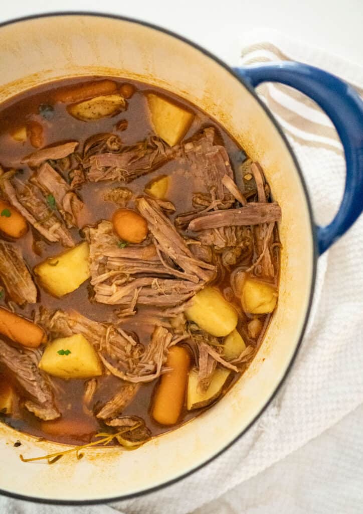 stovetop pot roast in a blue dutch oven