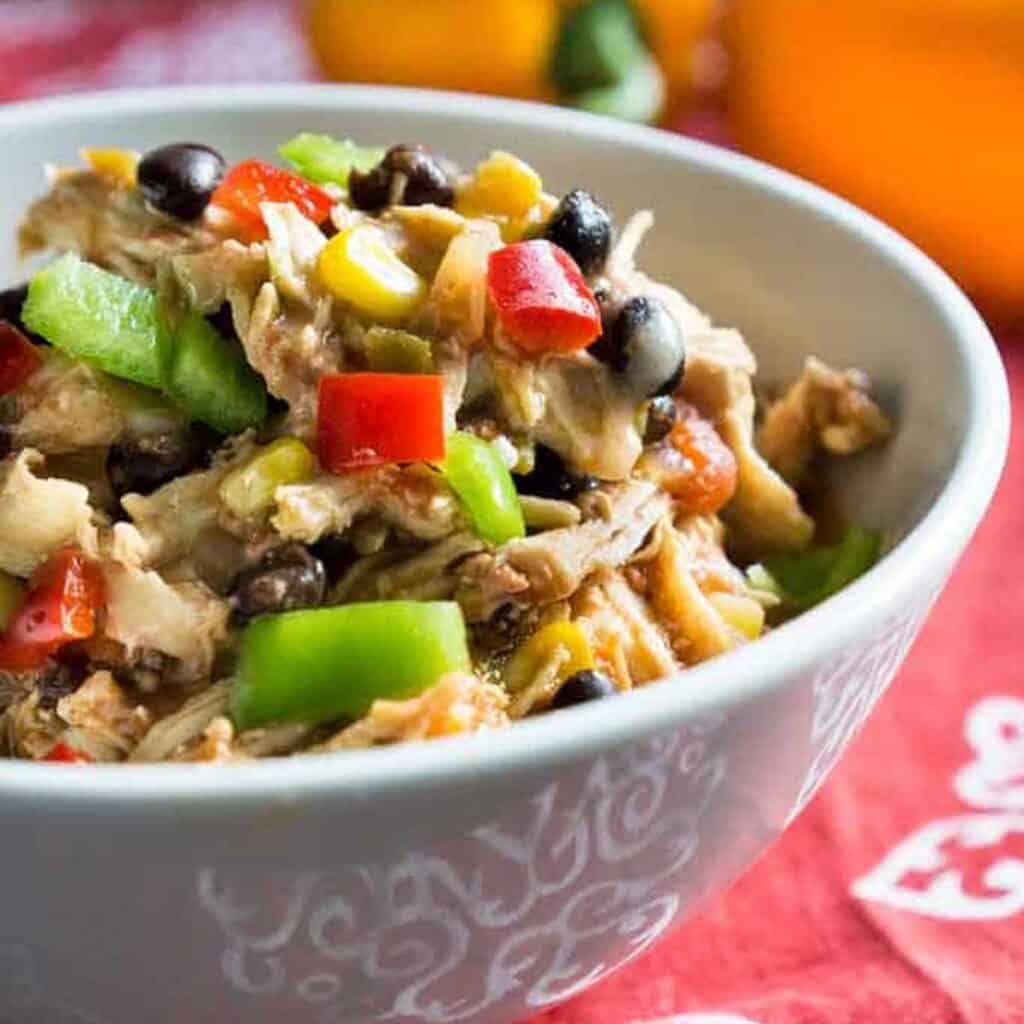 slow cooker Mexican shredded chicken in white bowl