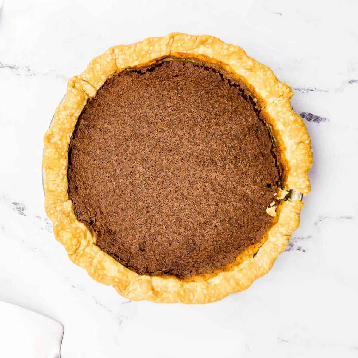 chocolate chess pie after baking on marble countertop