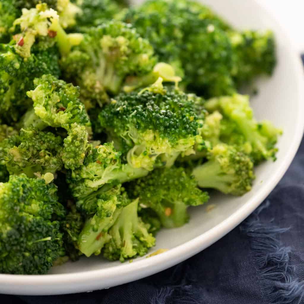 close up of italian broccoli in white serving bowl