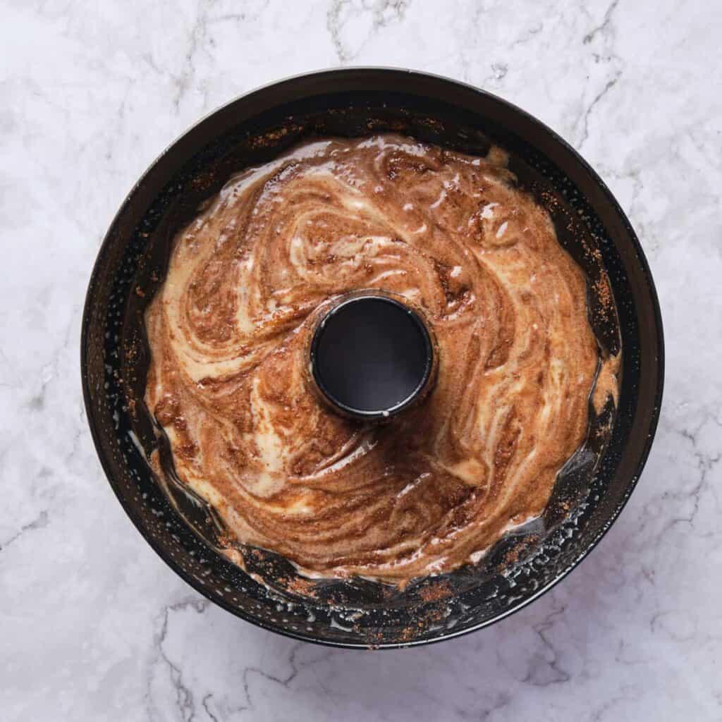cinnamon roll coffee cake batter in bundt pan before baking