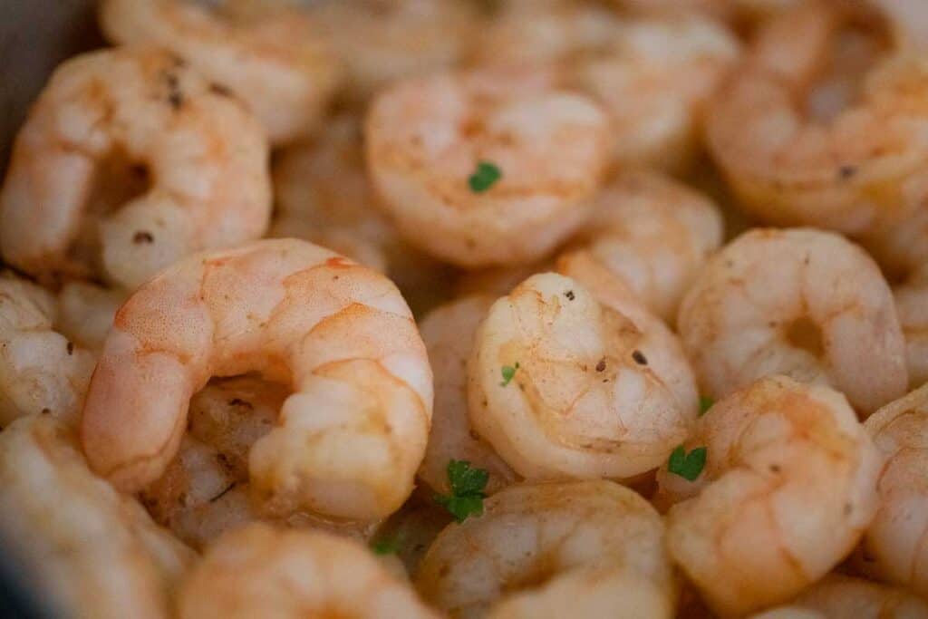 close up of pan fried shrimp with parsley