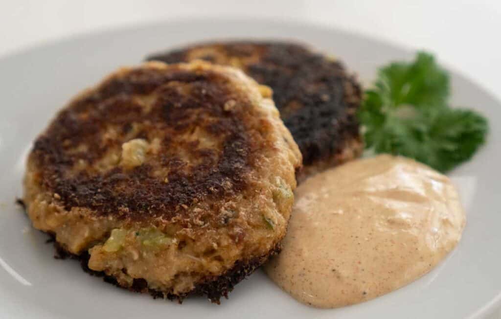 two crab cakes with remoulade sauce