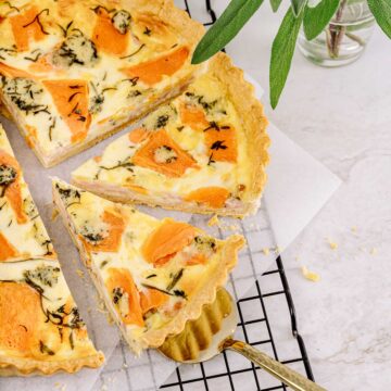 sliced quiche with one piece on serving spatula