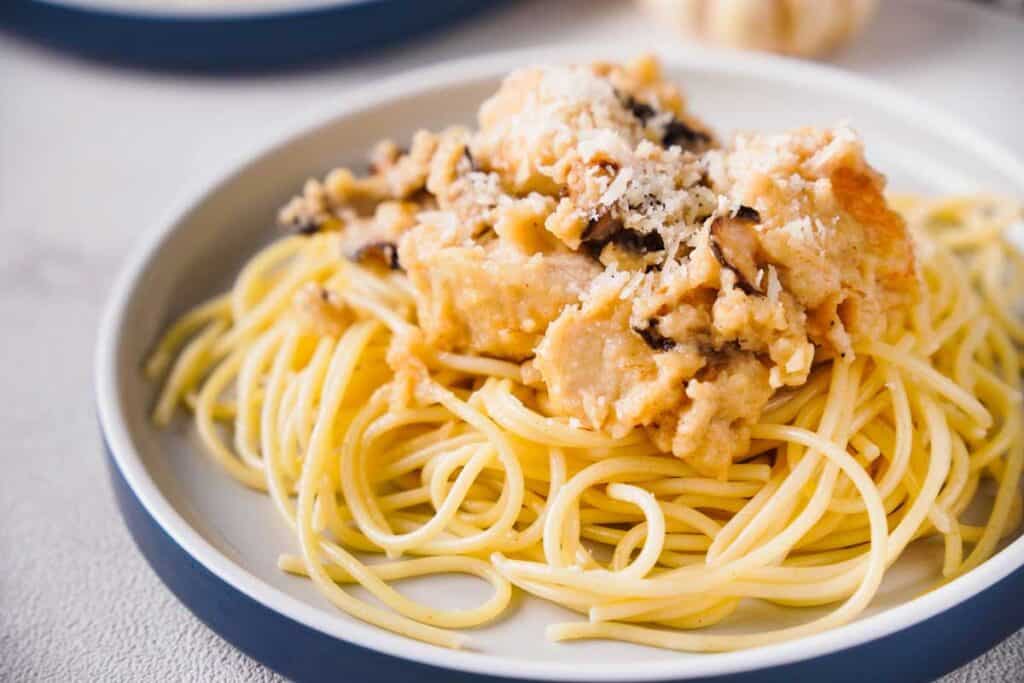 parmesan mushroom chicken and pasta on white plate