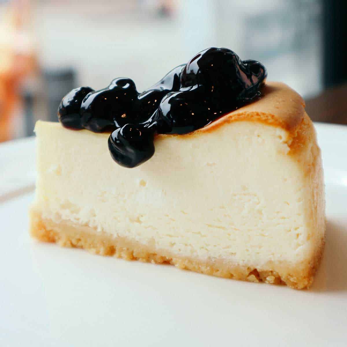 slice of cheesecake with blueberry sauce on top