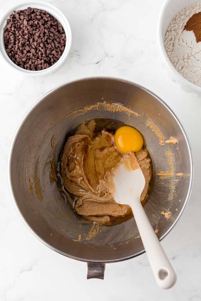 stirring cookie dough with egg