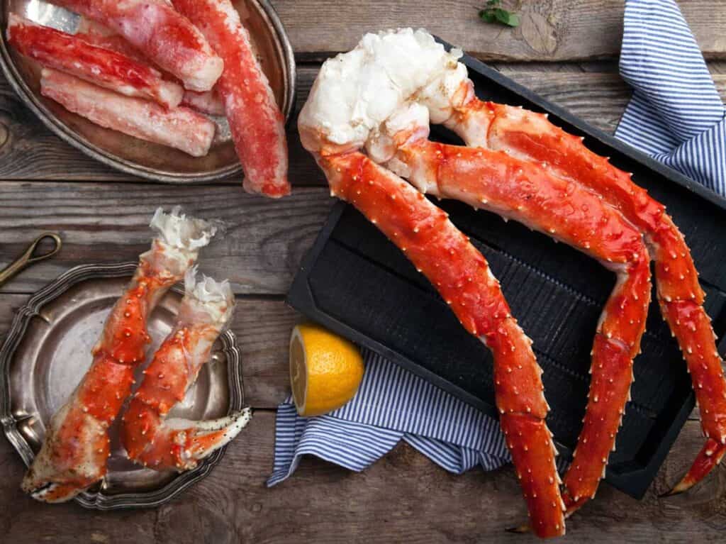 crab legs on table with half a lemon