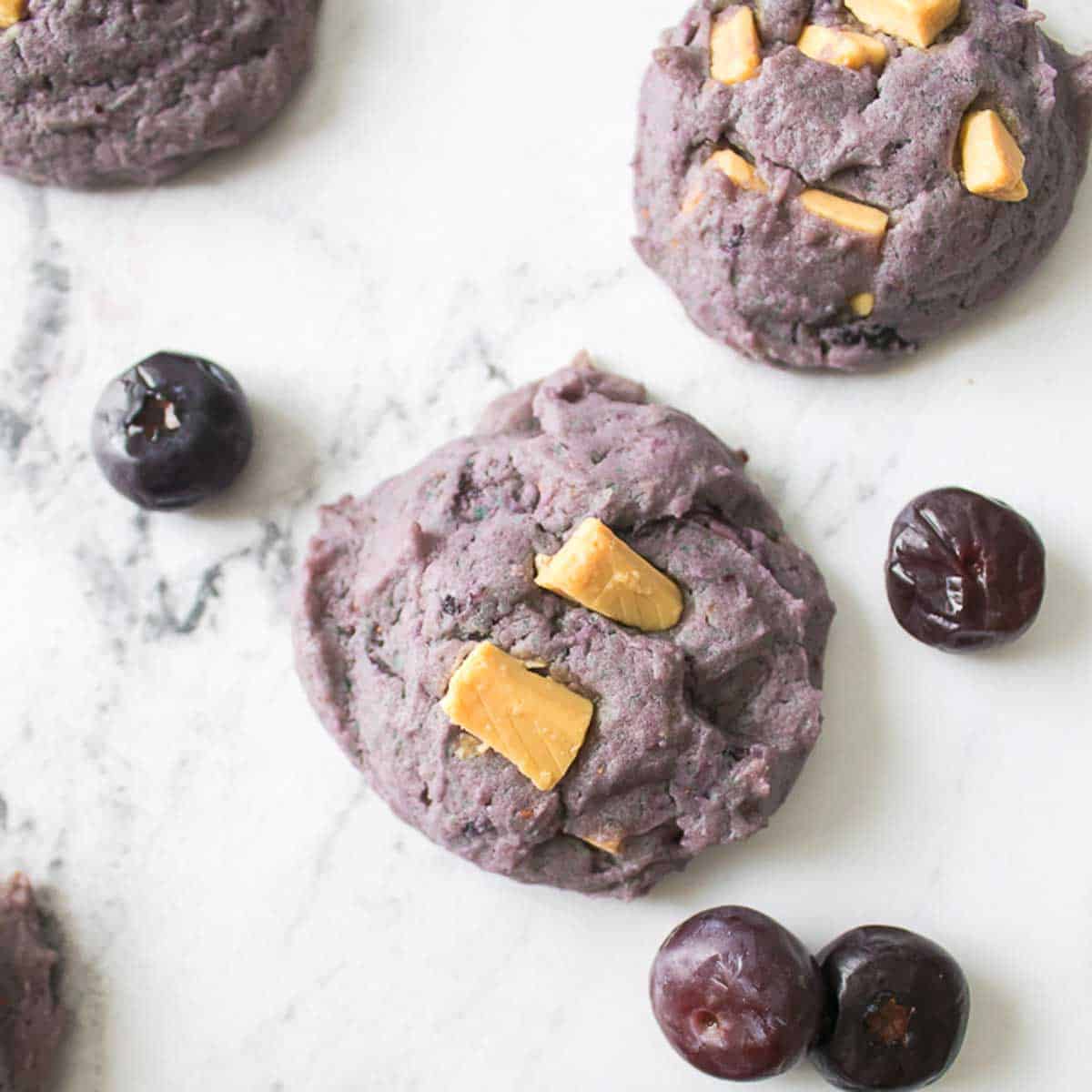 blueberry cookies with white chocolate chunks and four blueberries