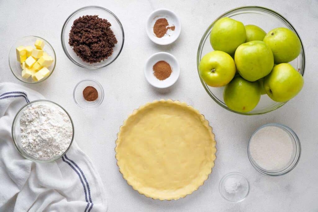 apple pie ingredients on marble countertop