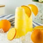 two frozen mimosas with orange slices
