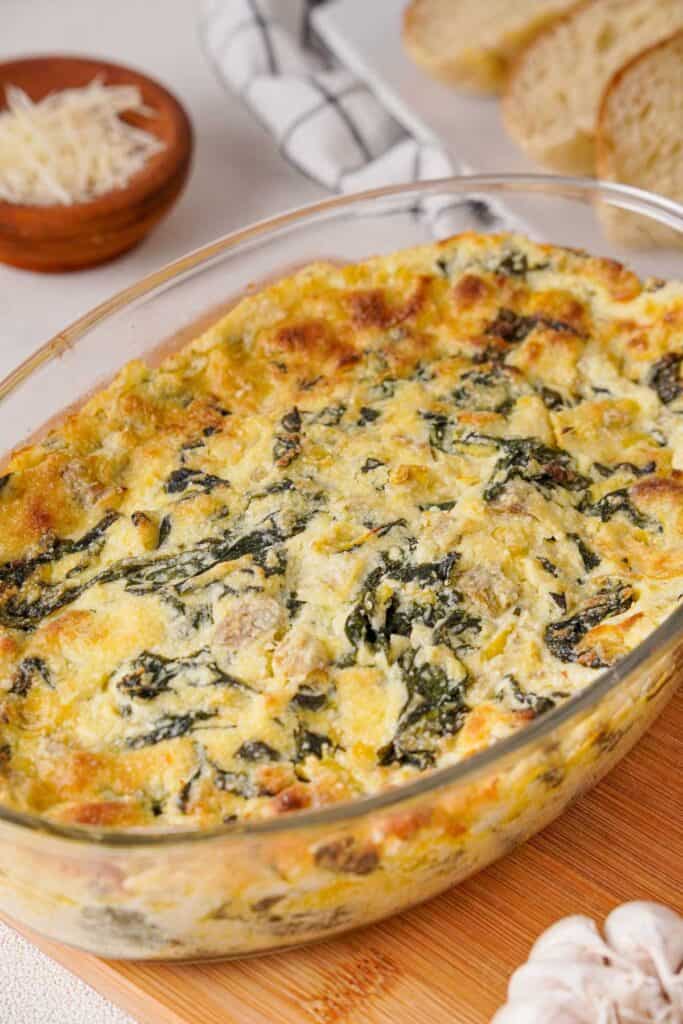 baked spinach artichoke dip in glass dish
