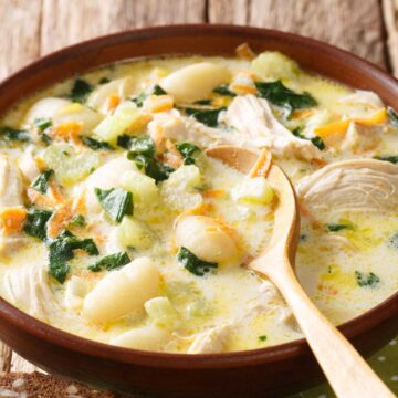 wood bowl of gnocchi soup with spoon