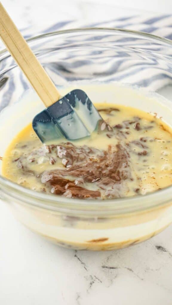 stirring condensed milk and melting chocolate together
