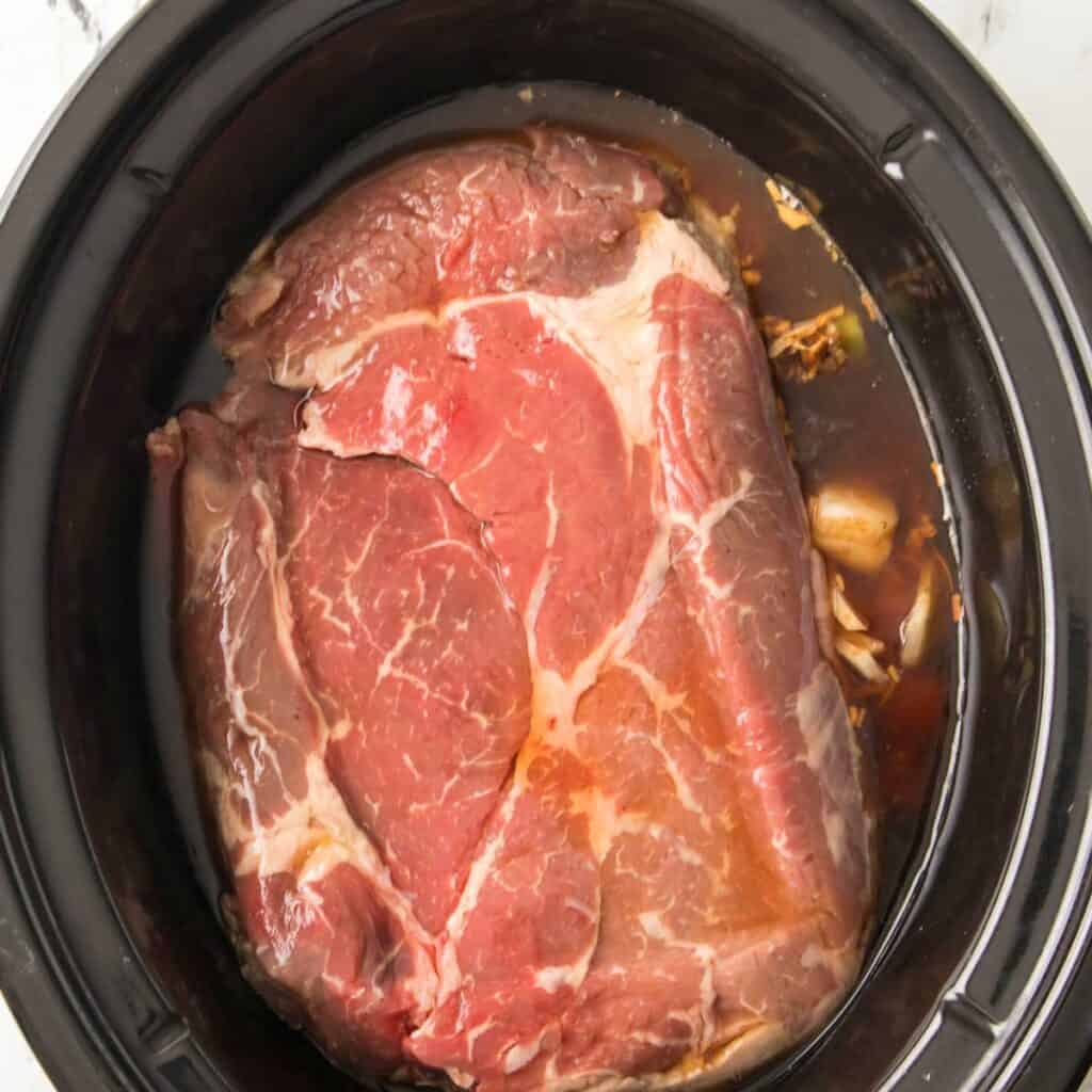 pot roast in slow cooker before cooking
