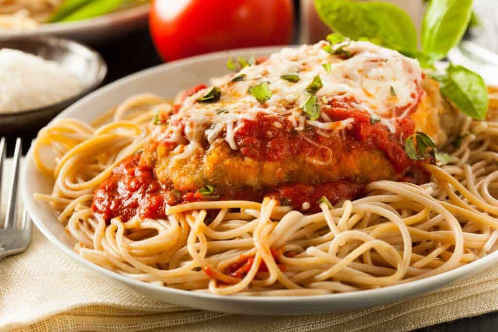 chicken parmesan over spaghetti noodles