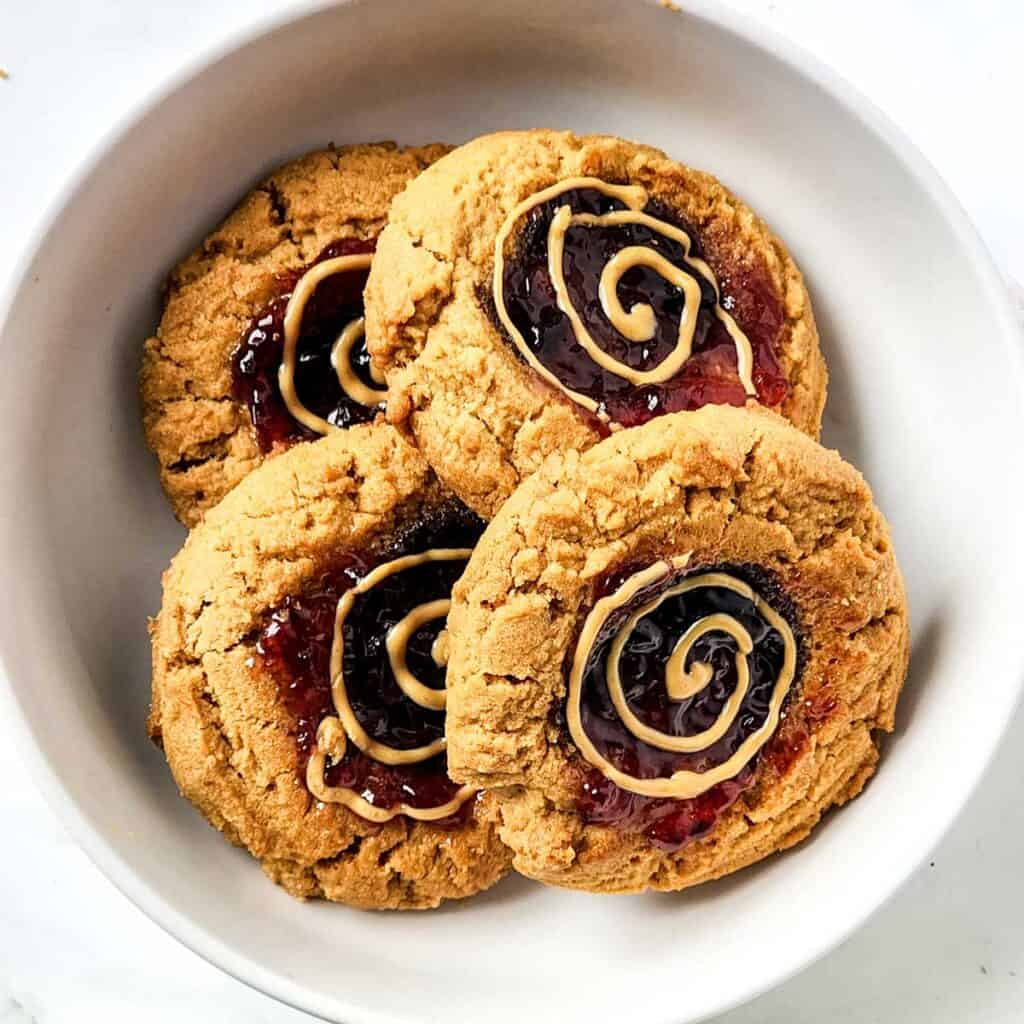 peanut butter and jelly cookies in white bowl