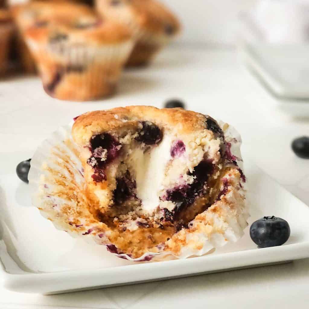 blueberry cream cheese muffin with bite taken out