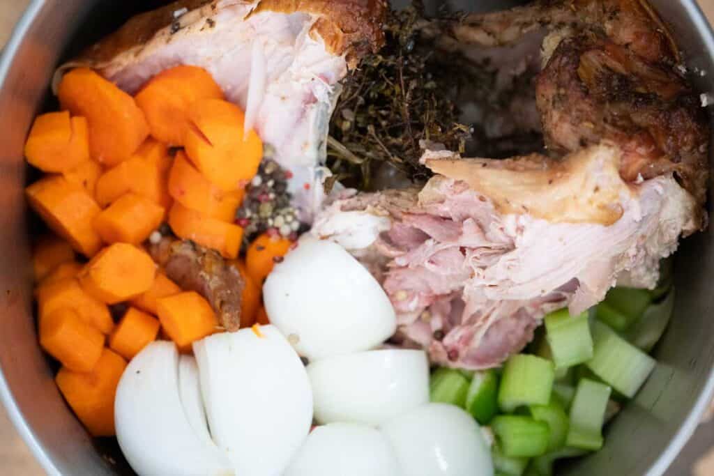 turkey carcass and vegetables in stock pot