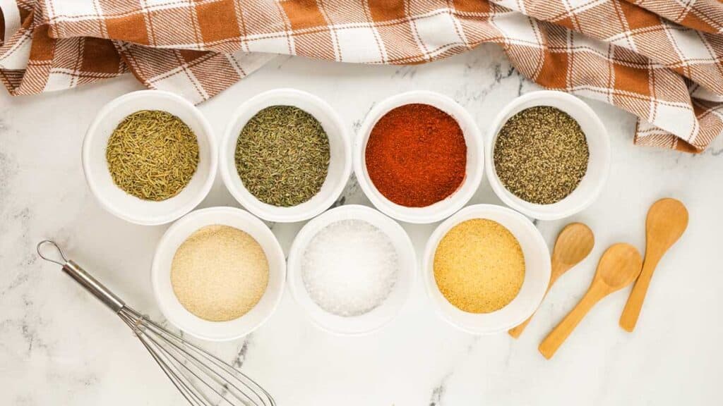 turkey rub ingredients in small bowls on marble counter