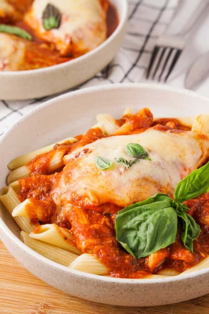 bowl with chicken parmesan over penne pasta