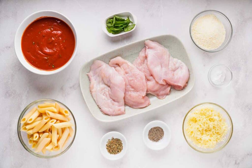 Instant Pot Chicken Parmesan ingredients on marble countertop