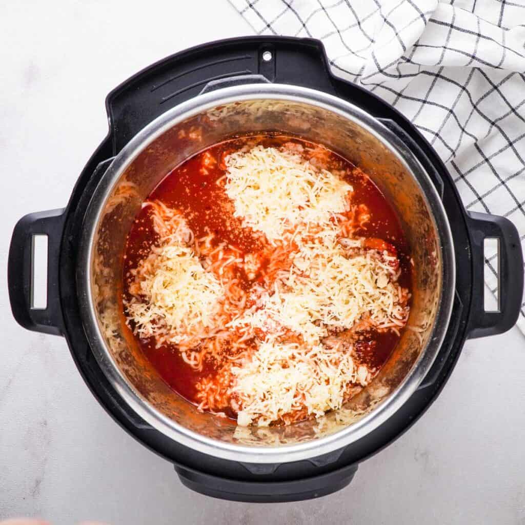 chicken topped with marinara and cheese in Instant Pot