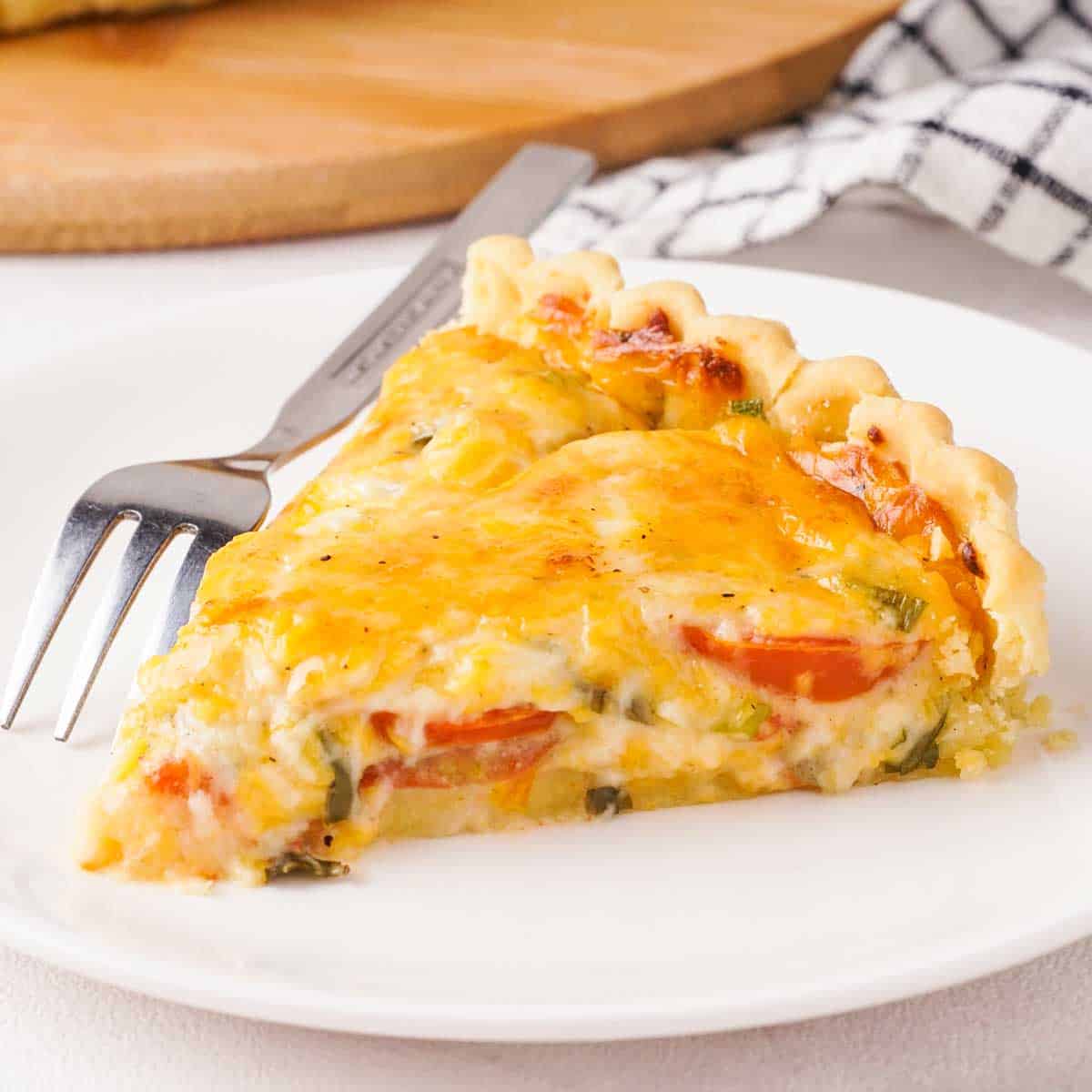 slice of Southern tomato pie on white plate