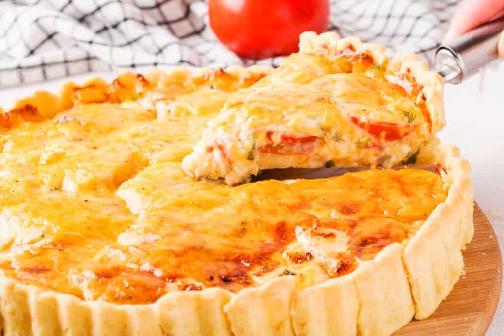 lifting slice of Southern tomato pie from rest of pie