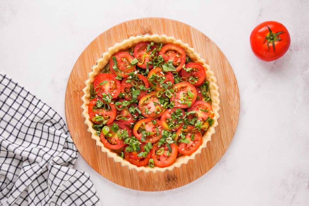 layers of tomato and herbs in pie crust