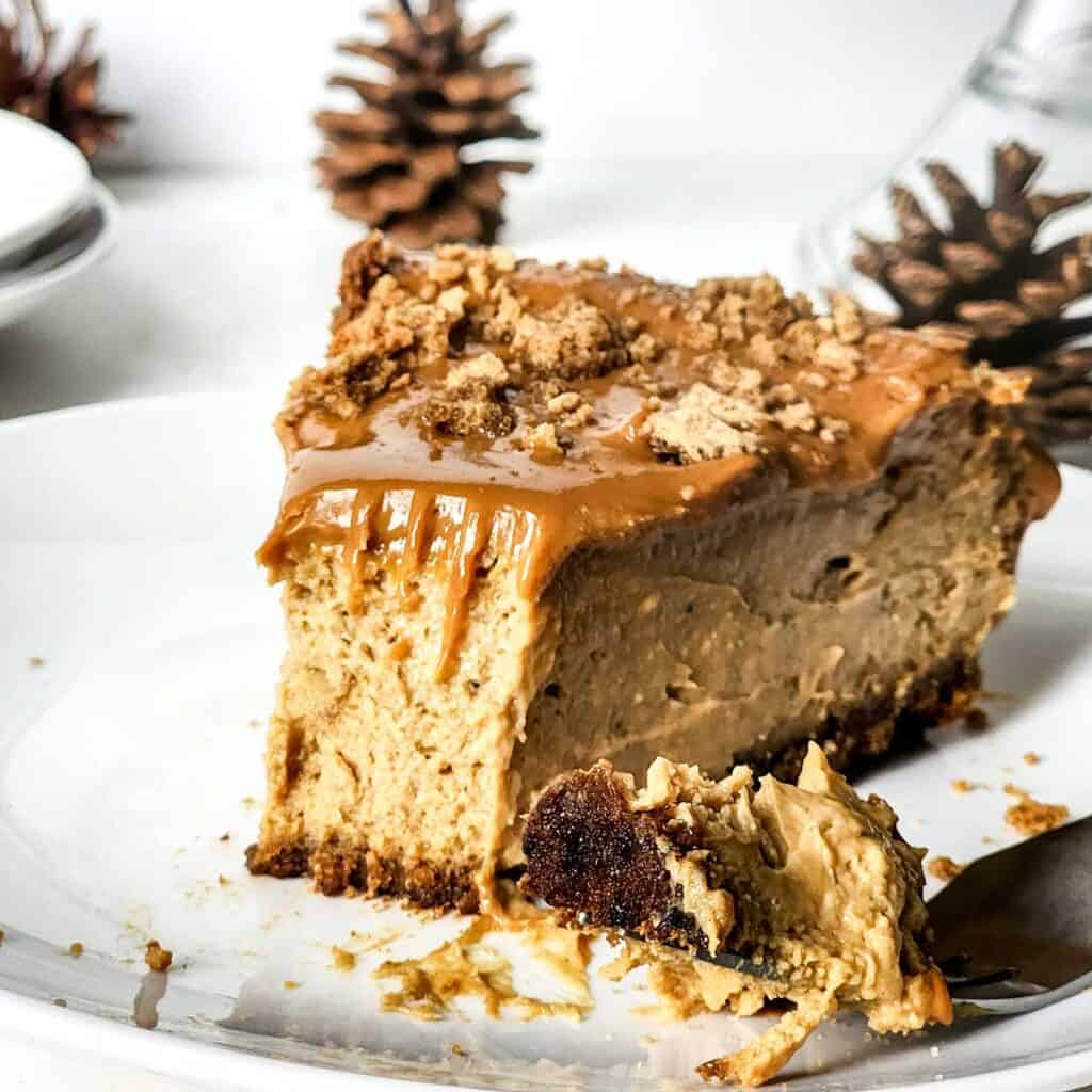 slice of gingerbread cheesecake with bite taken out on fork