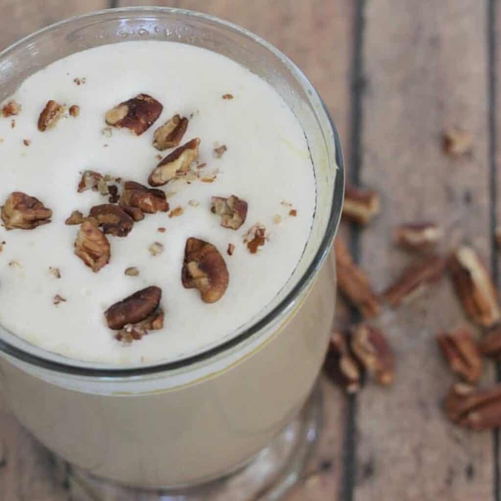 close up of praline latte topped with chopped pecans