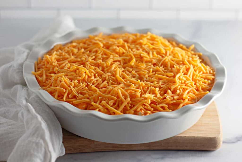 chicken dip topped with cheese before baking