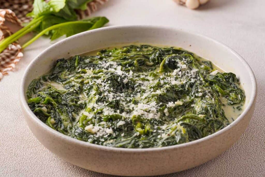 creamed spinach in off white bowl