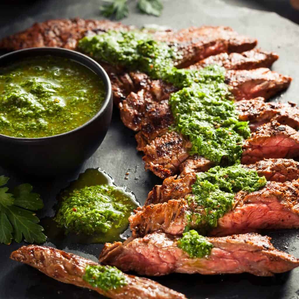 chimichurri steak on slate cutting board