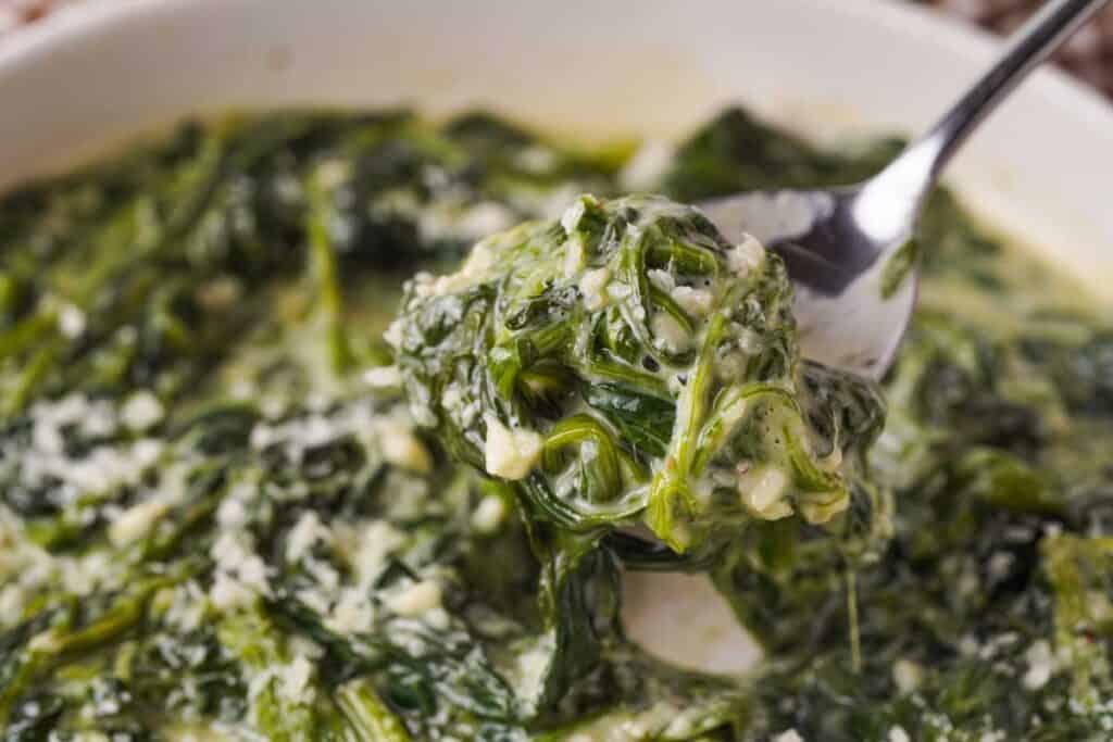 spoonful of creamed spinach over bowl