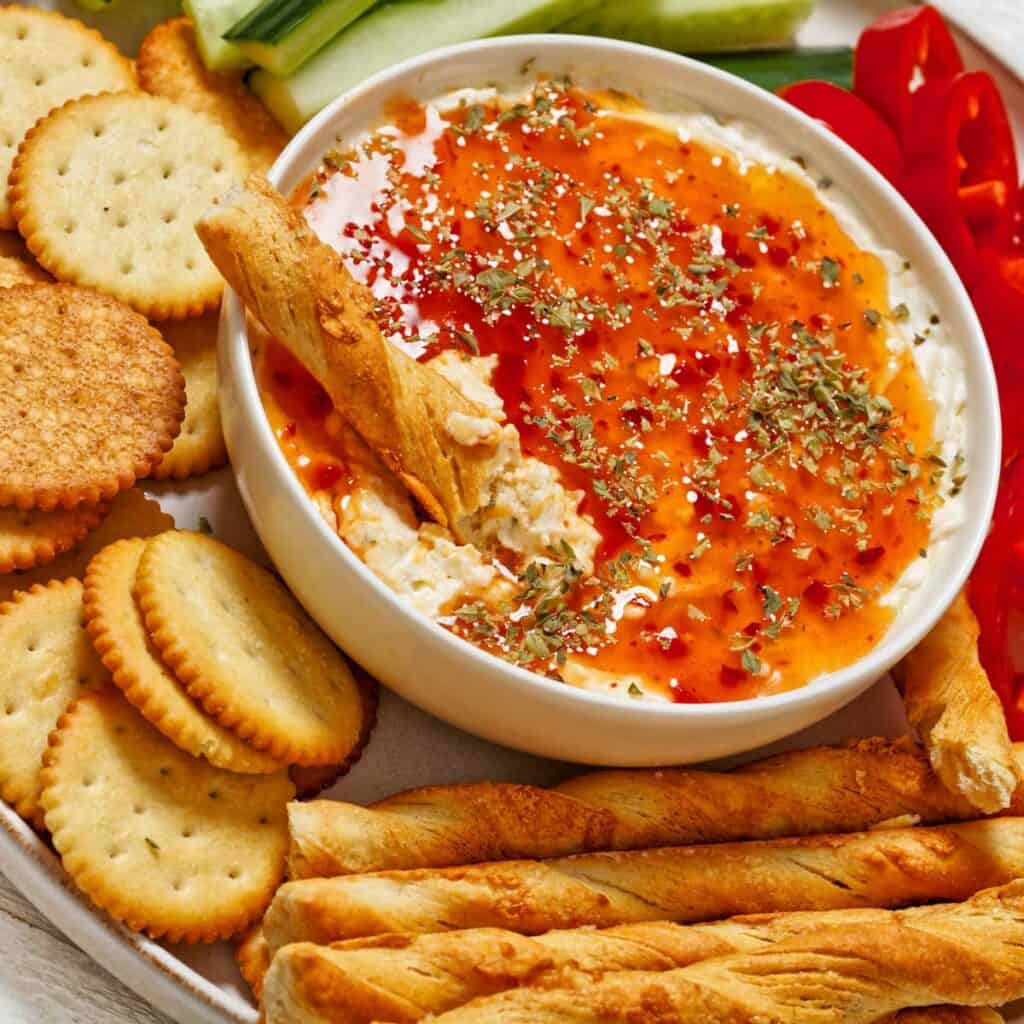 veggie and cracker tray with pepper jelly cheese dip