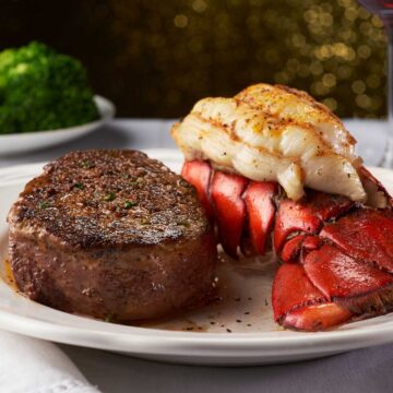 white plate with steak and lobster tail