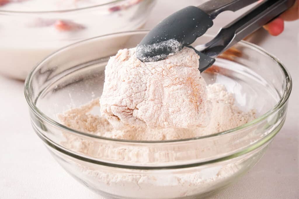 dredging chicken breast in flour