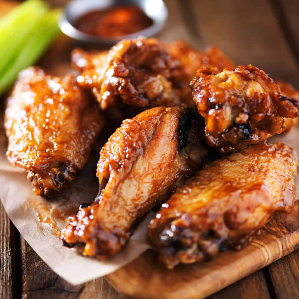 close up of chicken wings with celery