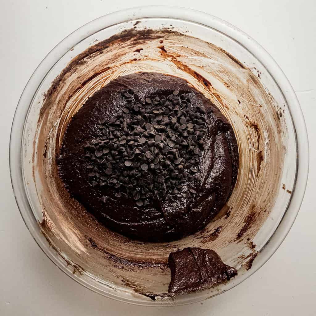 chocolate batter with chocolate chips in glass bowl