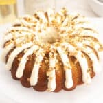 carrot bundt cake with cream cheese frosting and chopped pecans