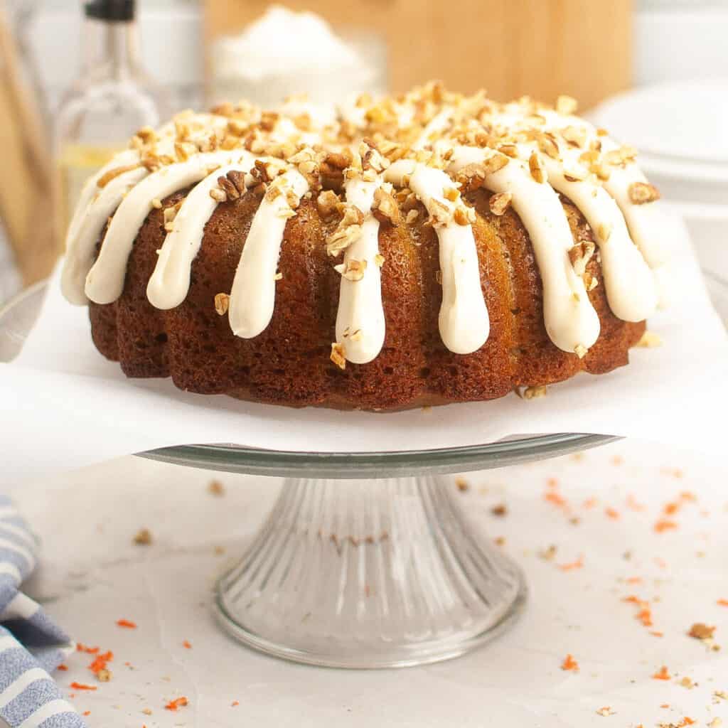 side view of carrot bundt cake with cream cheese frosting