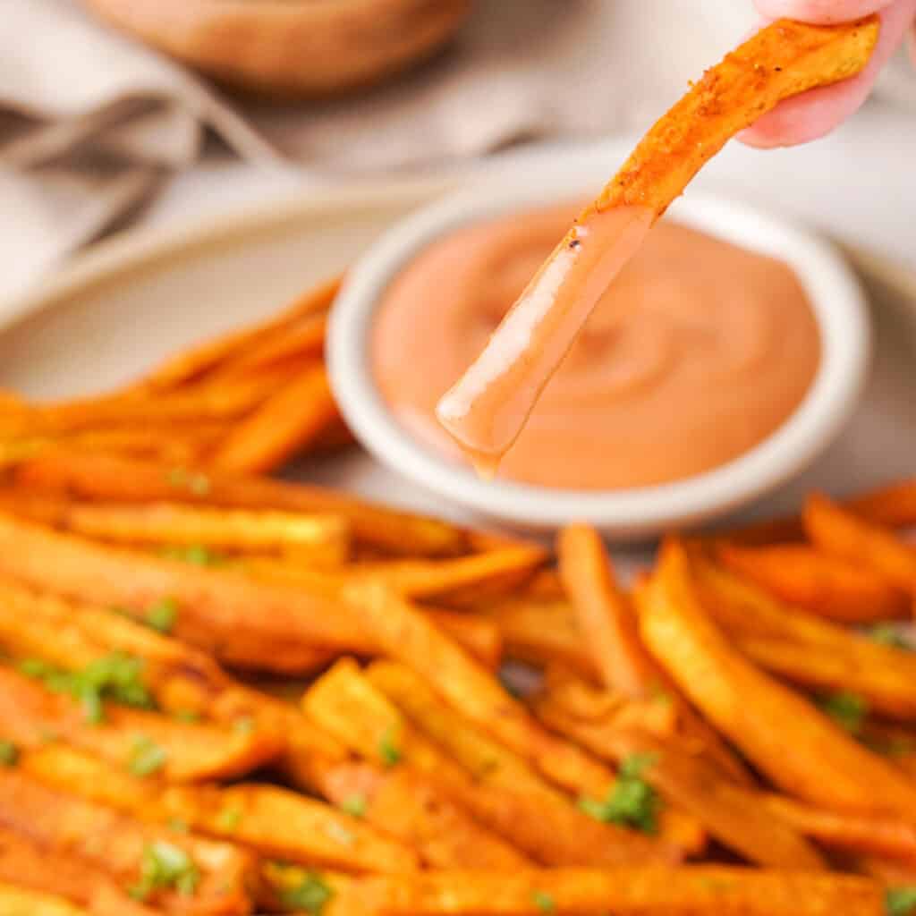 sweet potato fry with dipping sauce on end