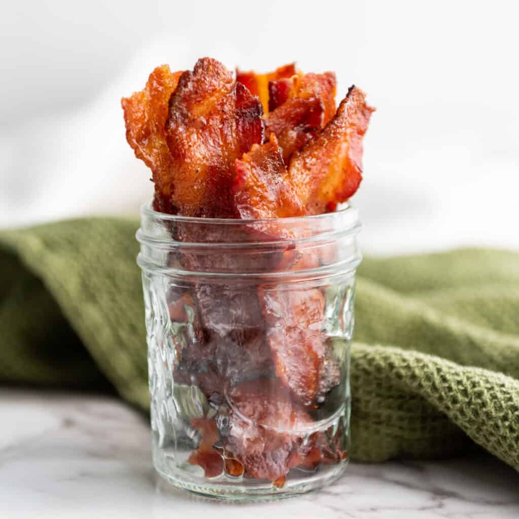 jar with pieces of candied bacon in it