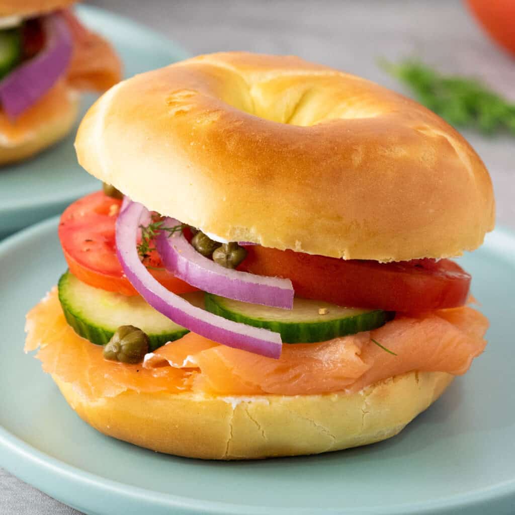 smoked salmon bagel on blue plate