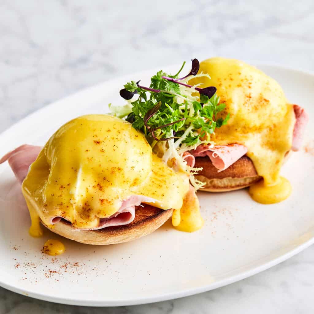 eggs benedict on white plate