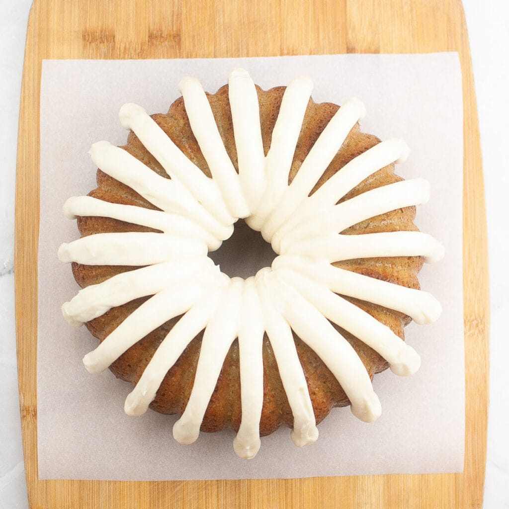 overhead view of bundt cake with cream cheese frosting